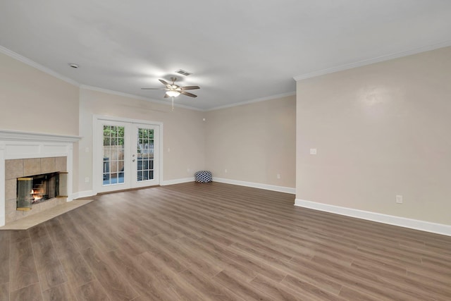 unfurnished living room with ornamental molding, french doors, wood finished floors, and baseboards