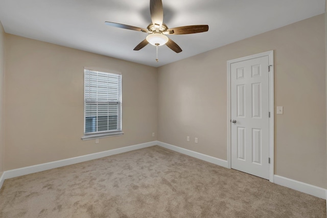 unfurnished room with light colored carpet, ceiling fan, and baseboards