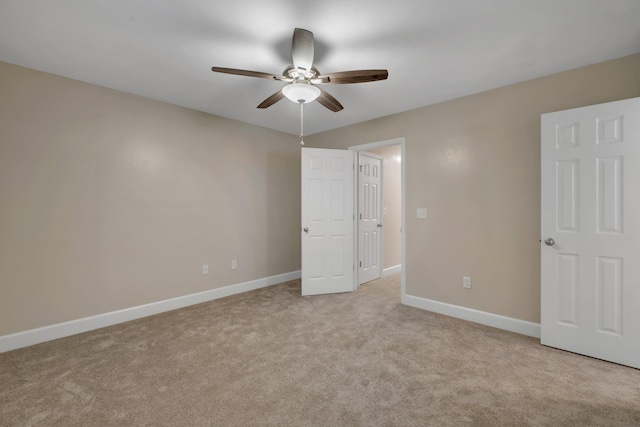 unfurnished bedroom featuring light carpet, ceiling fan, and baseboards