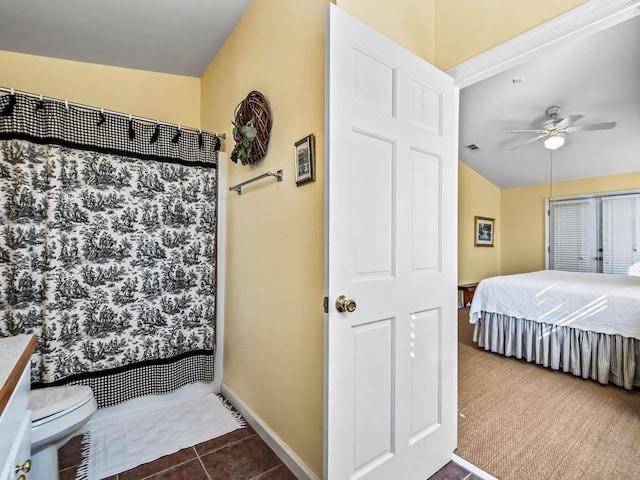 bathroom with tile patterned flooring, vanity, ceiling fan, and toilet