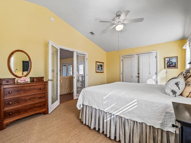 bedroom with lofted ceiling, light carpet, a closet, and ceiling fan