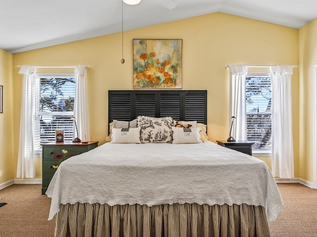 carpeted bedroom with vaulted ceiling and ceiling fan