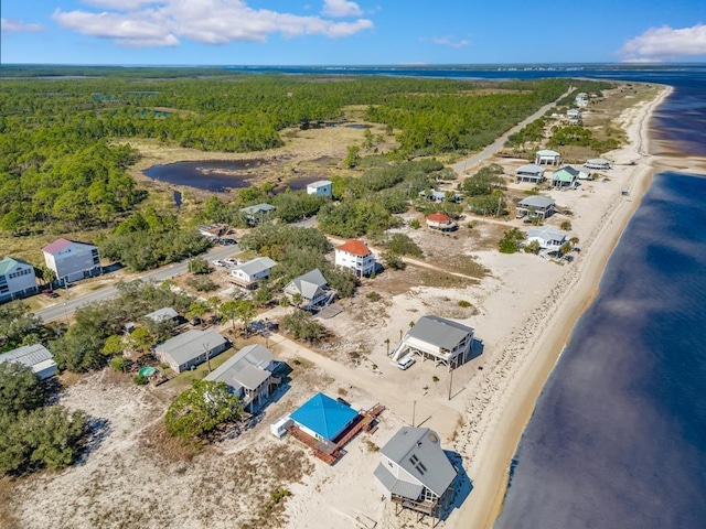 birds eye view of property featuring a water view and a view of the beach