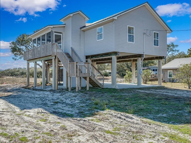 back of property featuring a sunroom and a patio