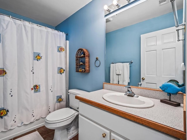 full bathroom with tile patterned flooring, vanity, shower / bath combo, and toilet