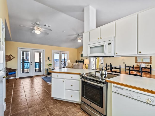 kitchen with french doors, white appliances, white cabinetry, and kitchen peninsula