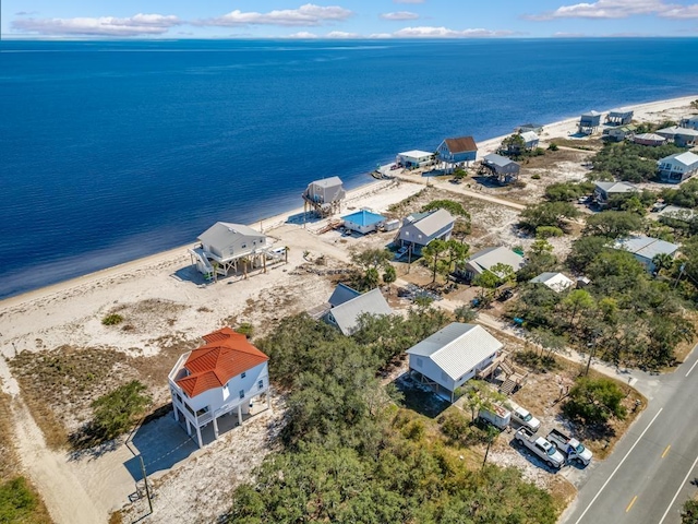 birds eye view of property with a water view and a view of the beach