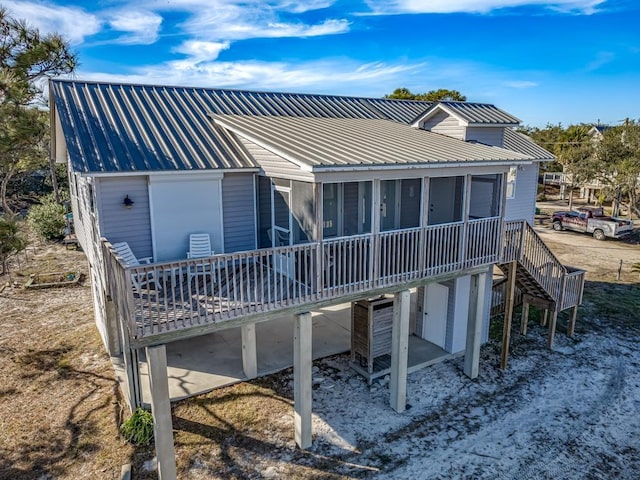 rear view of house with a sunroom