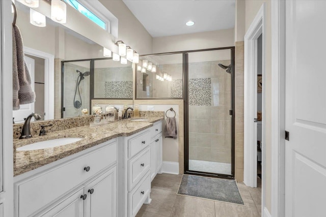 bathroom with tile patterned flooring, vanity, and an enclosed shower