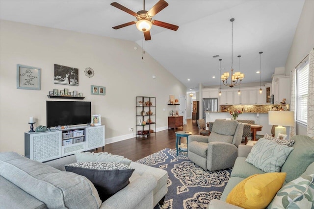 living room featuring dark hardwood / wood-style flooring, high vaulted ceiling, and ceiling fan with notable chandelier