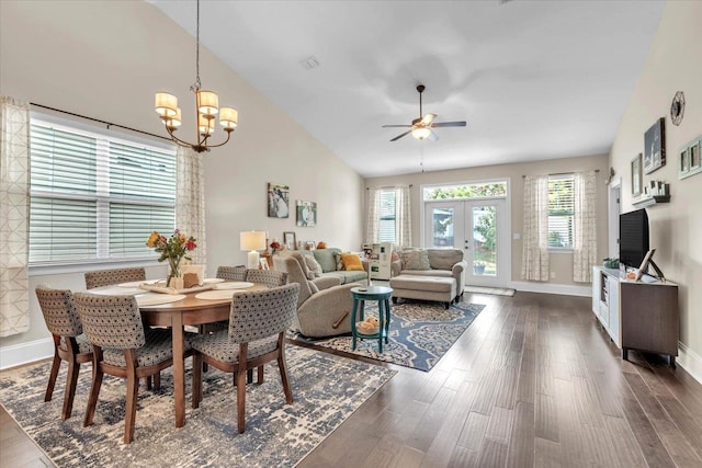 dining room featuring french doors, ceiling fan with notable chandelier, high vaulted ceiling, and dark wood-type flooring