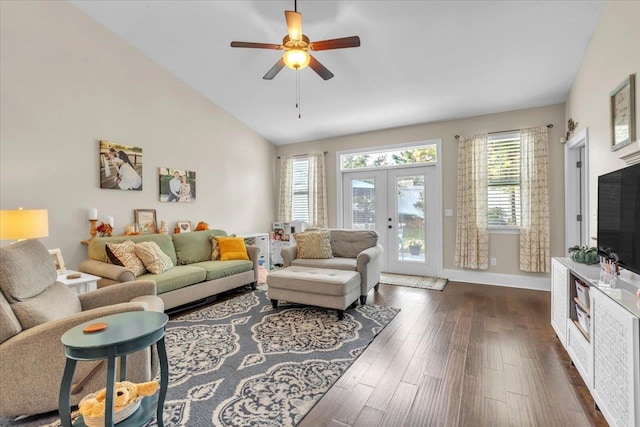 living room featuring dark hardwood / wood-style floors, ceiling fan, french doors, and vaulted ceiling