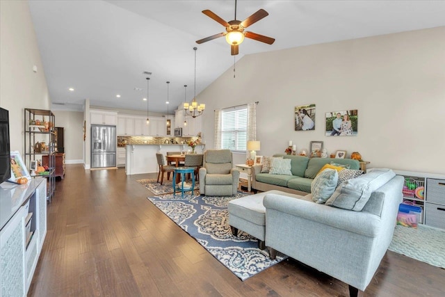 living room featuring ceiling fan with notable chandelier, high vaulted ceiling, and dark wood-type flooring