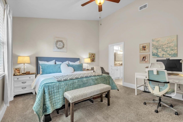 carpeted bedroom featuring connected bathroom, ceiling fan, and high vaulted ceiling