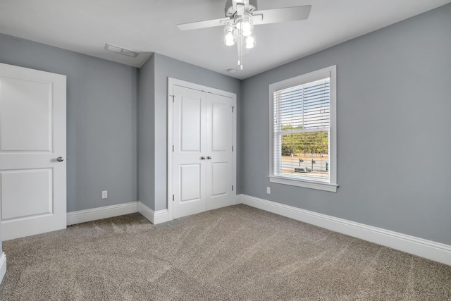 unfurnished bedroom featuring a closet, carpet flooring, and ceiling fan