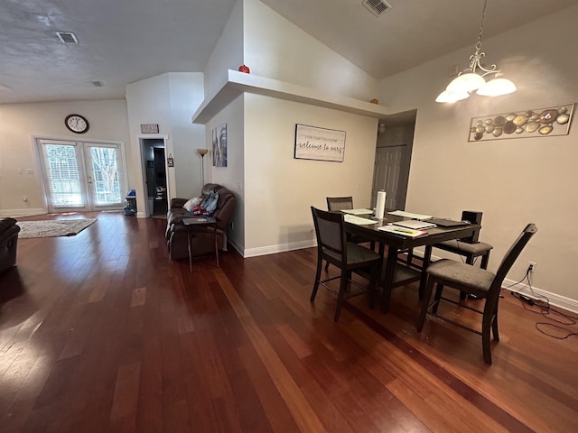 dining space with dark wood-type flooring, high vaulted ceiling, and french doors