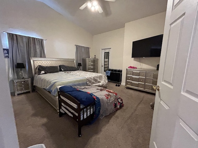 bedroom with ceiling fan, lofted ceiling, and dark carpet