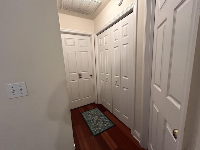 hall with dark wood-type flooring