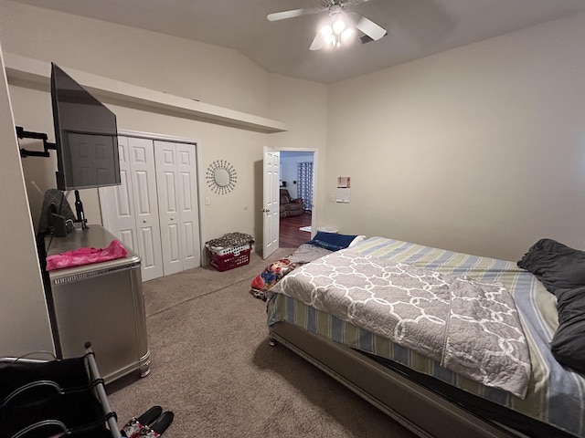 bedroom with ceiling fan, a closet, lofted ceiling, and carpet