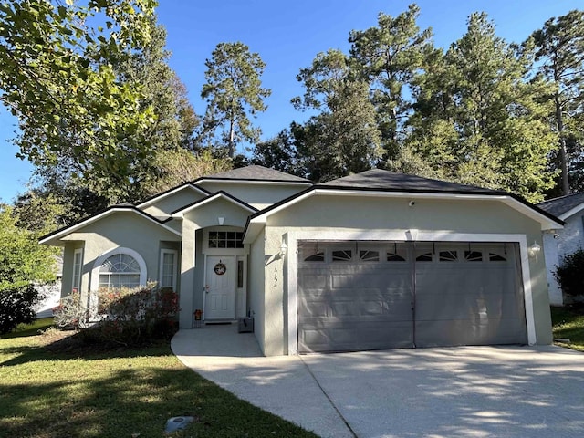 single story home with a garage and a front yard