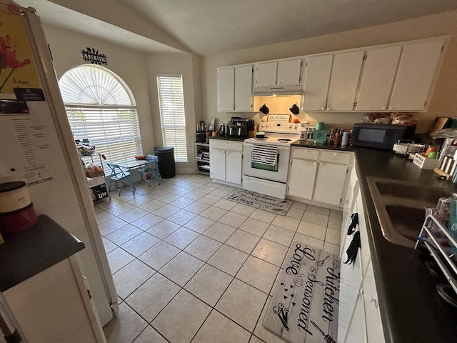 kitchen with white cabinetry, vaulted ceiling, light tile patterned floors, and white range with electric cooktop