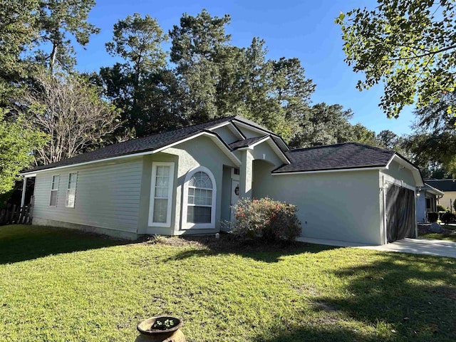 view of front of house with a garage and a front lawn