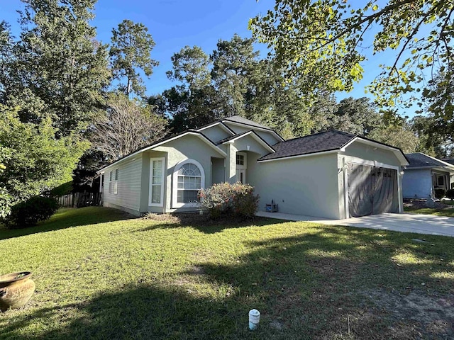 view of front of home featuring a garage and a front lawn