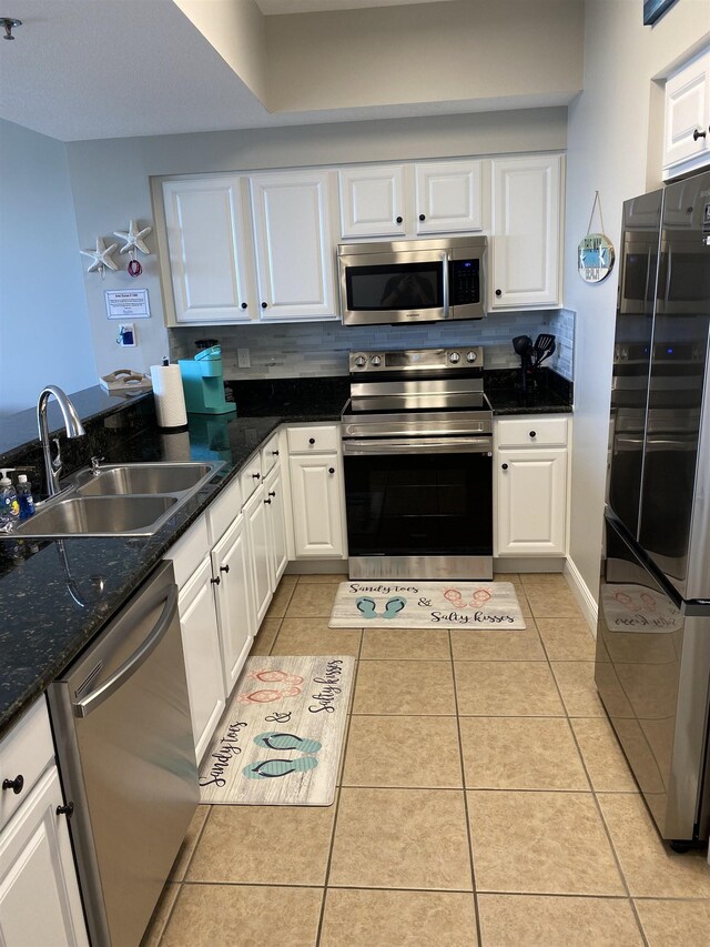 122 Seascape Dr Unit 1406, Destin, FL 32550 - kitchen featuring stainless steel appliances, a sink, white cabinets, and light tile patterned flooring