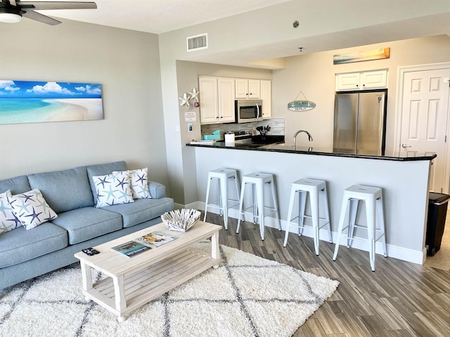 122 Seascape Dr Unit 1406, Destin, FL 32550 - living room with wood finished floors, a ceiling fan, and baseboards