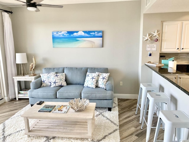 122 Seascape Dr Unit 1406, Destin, FL 32550 - living area featuring light wood-style floors, a ceiling fan, and baseboards