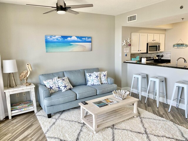 122 Seascape Dr Unit 1406, Destin, FL 32550 - living area with ceiling fan, light wood-style floors, and baseboards