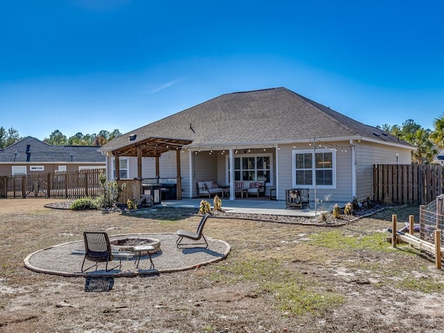 back of house with a fire pit and a patio