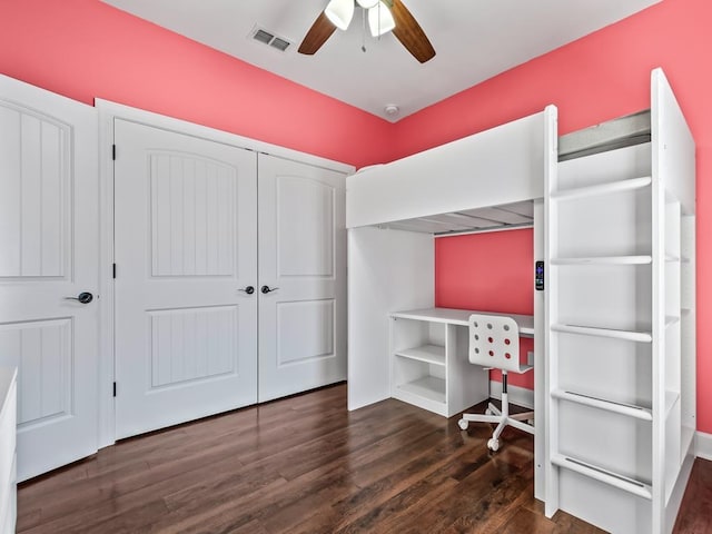 unfurnished bedroom featuring a closet, ceiling fan, and dark hardwood / wood-style flooring