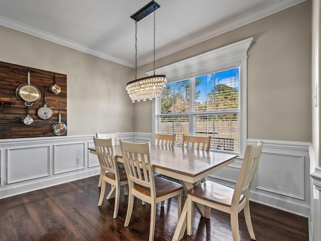 dining space featuring ornamental molding, dark wood-type flooring, and an inviting chandelier