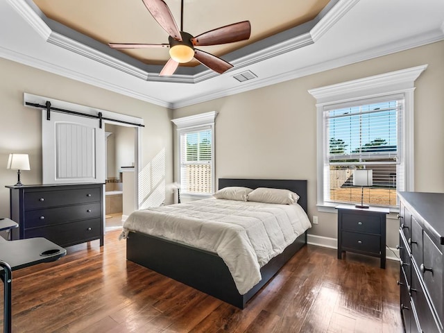 bedroom featuring a raised ceiling, a barn door, ceiling fan, and ornamental molding