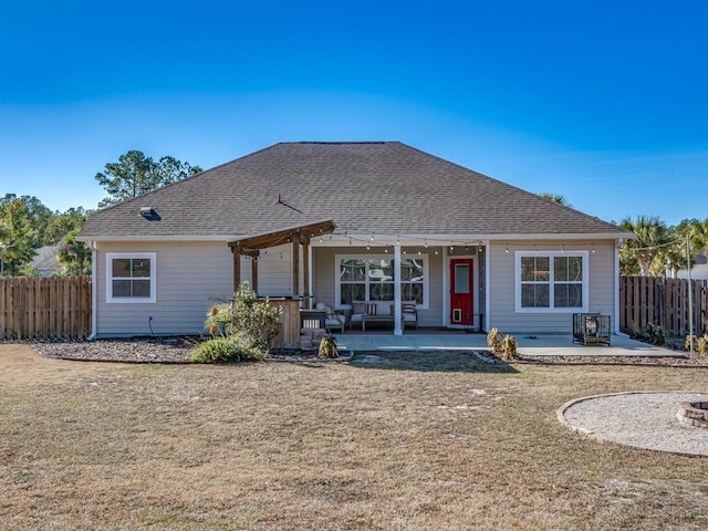 back of house with a yard and a patio