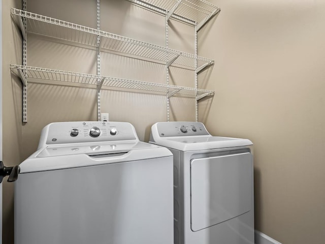 clothes washing area with washer and dryer