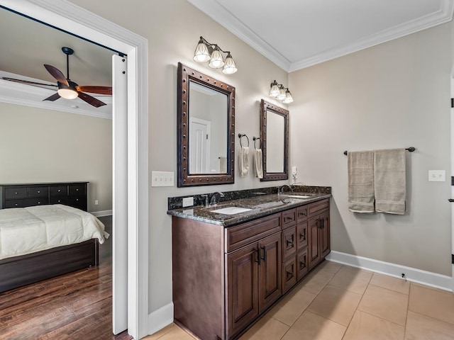 bathroom with tile patterned flooring, ceiling fan, crown molding, and vanity