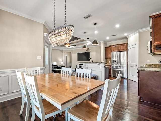 dining space with ceiling fan with notable chandelier, dark hardwood / wood-style floors, and ornamental molding