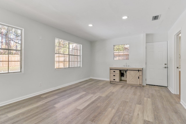 unfurnished living room featuring light wood-type flooring