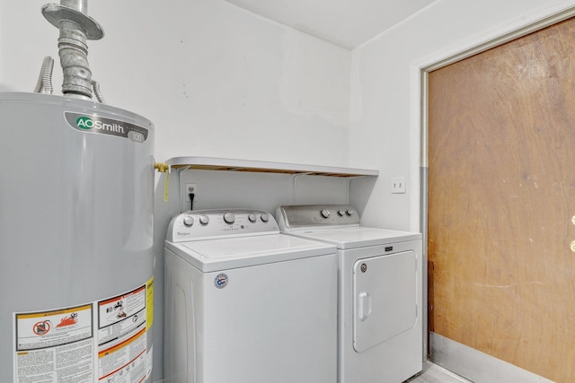 laundry room with water heater and washing machine and dryer