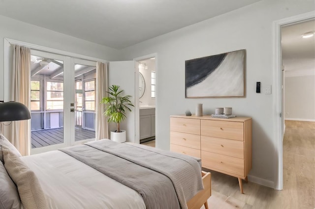 bedroom featuring connected bathroom, access to exterior, and light hardwood / wood-style floors