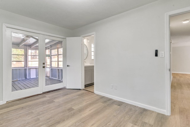 empty room with a healthy amount of sunlight and light hardwood / wood-style flooring