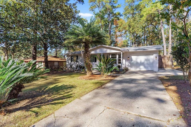 single story home featuring a garage and a front yard