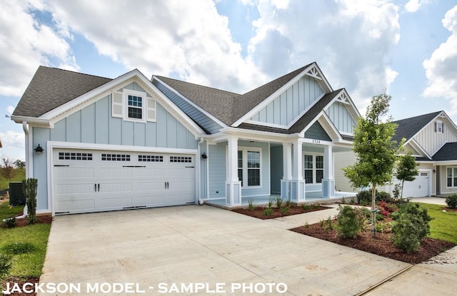 craftsman-style house with a garage, a porch, and central AC