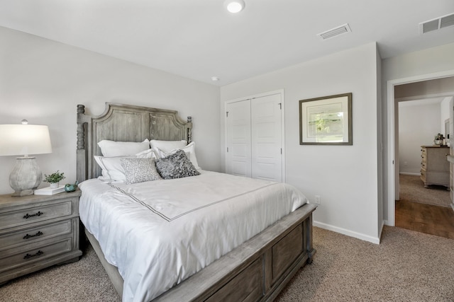 bedroom featuring light colored carpet and a closet