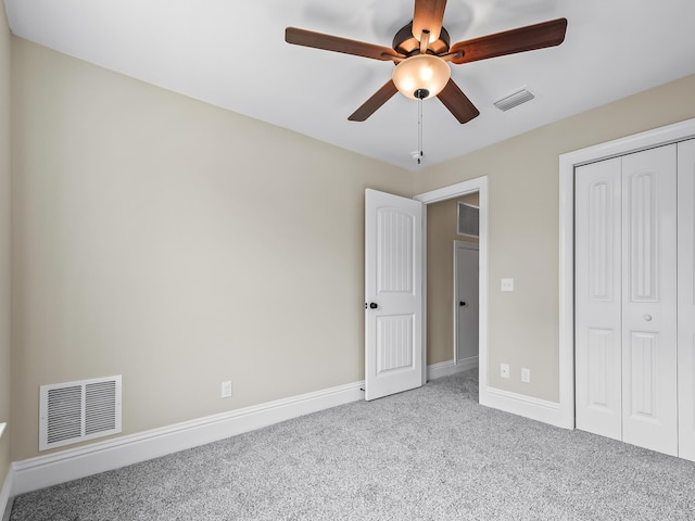 unfurnished bedroom with a closet, ceiling fan, and light colored carpet