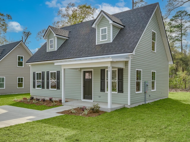 cape cod home with a front yard and a porch