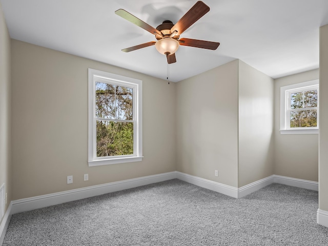 carpeted empty room featuring ceiling fan