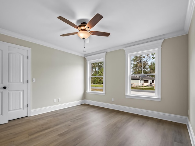 spare room with dark hardwood / wood-style flooring, ceiling fan, and ornamental molding